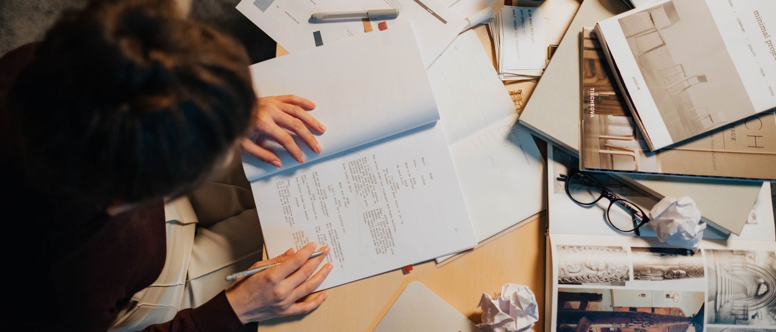 Printed enquiries and notes spread across a desk
