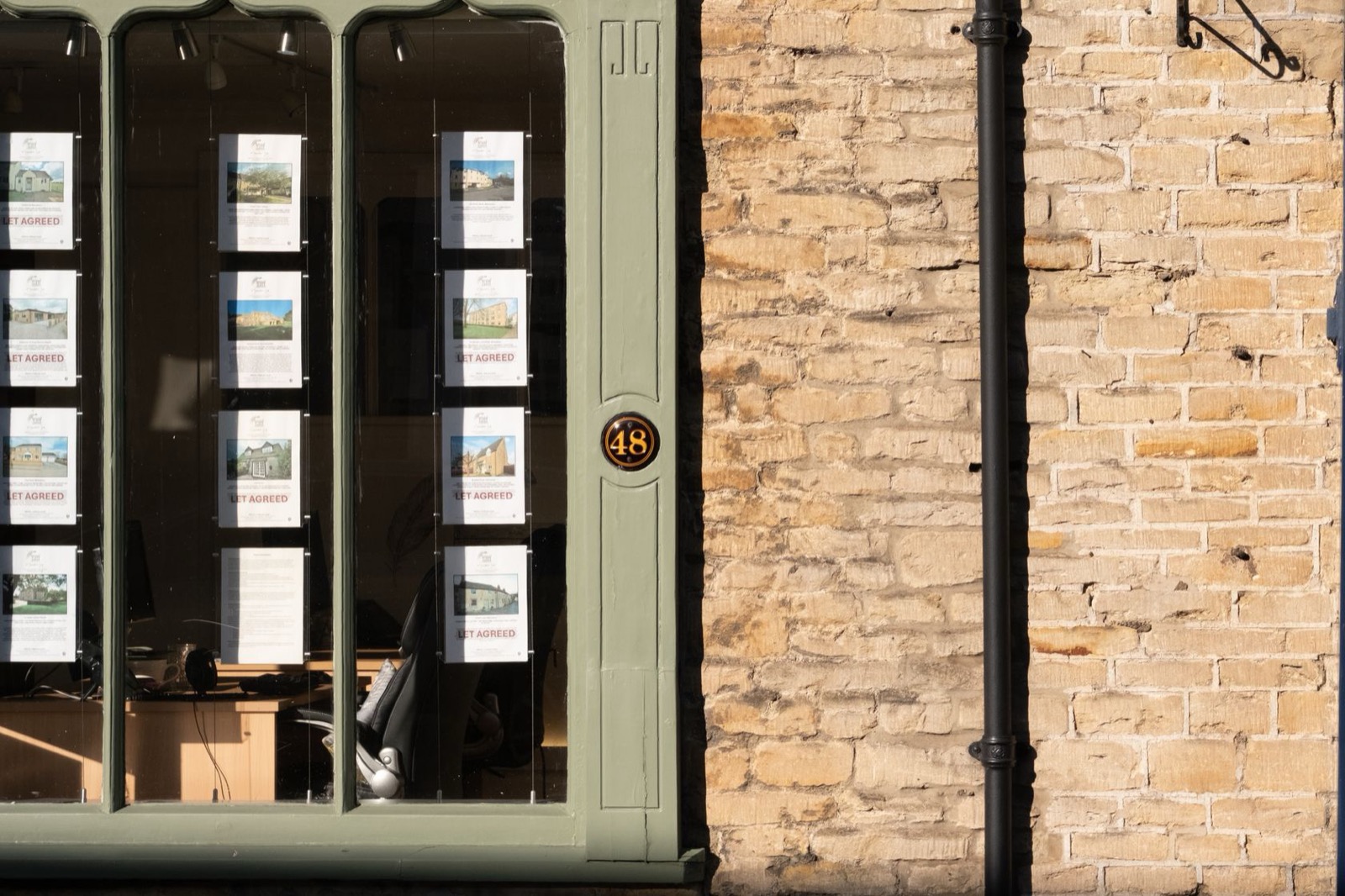 Property cards in the window of a UK estate agency