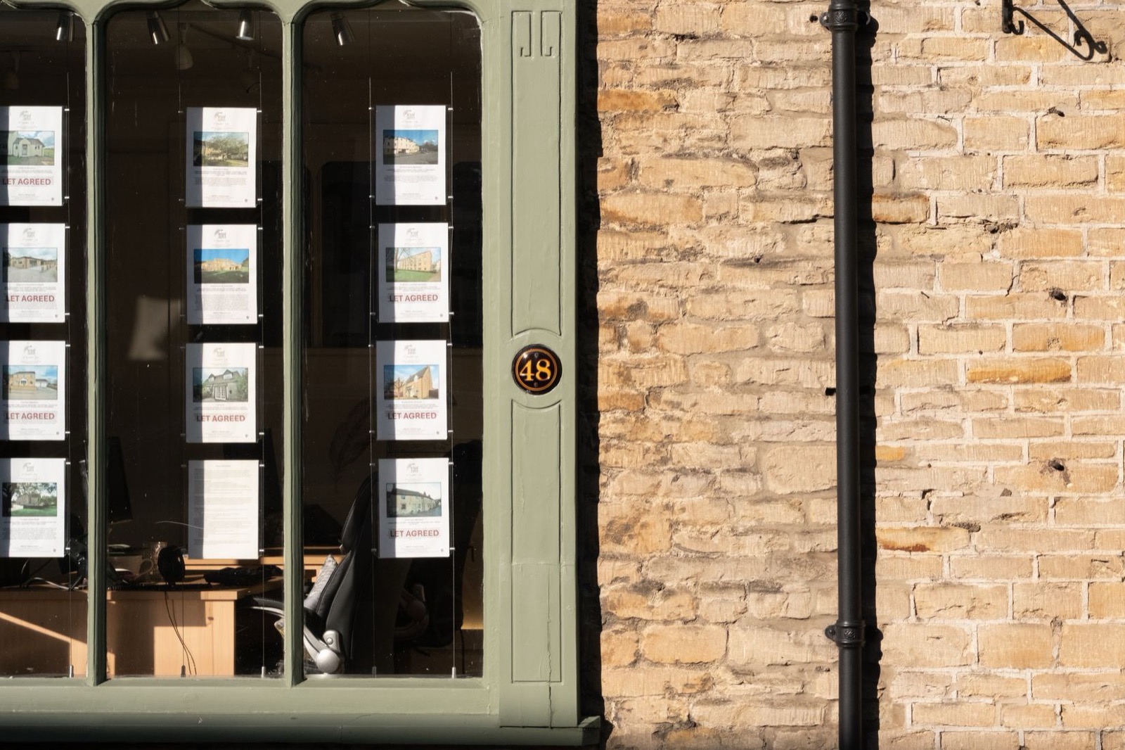 Property cards in the window of a UK estate agency